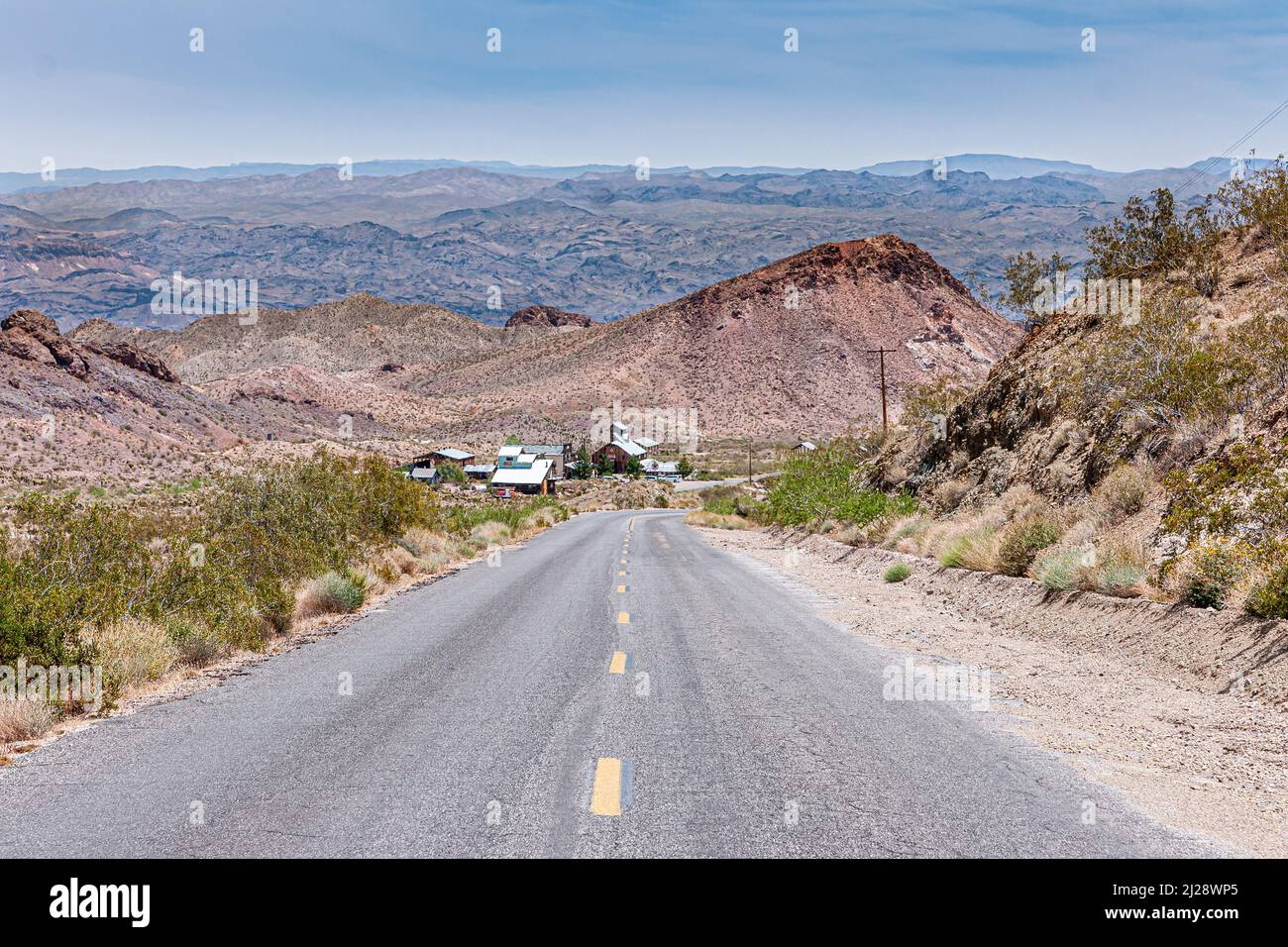 Nelson, Nevada, USA - May 21, 2011: Caltex gas station and adjacent stores at bottom of route 165 in wide dry desert environment with hills as far as Stock Photo