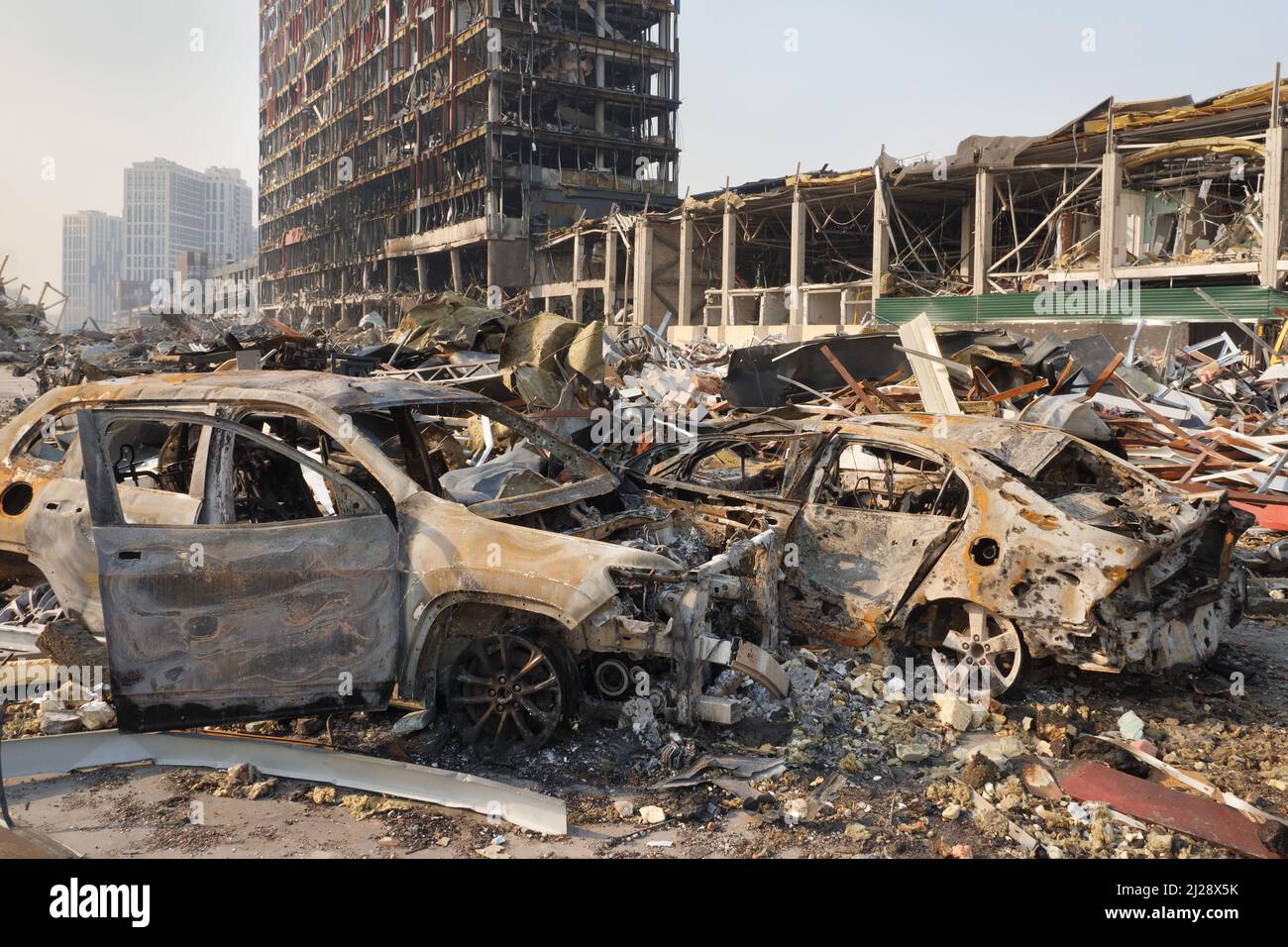 Russia war damage building destruction city war ruins city damage car. Terror attack bomb shell of civilian bombed. Disaster area. 2022 Russian Stock Photo