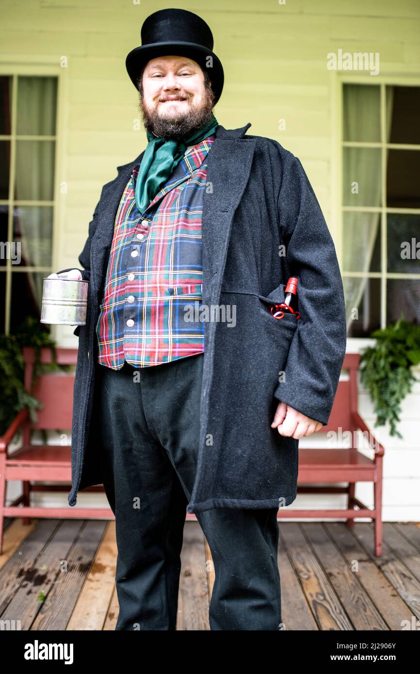 historic reenactment actor for Christmas time at the Fort Nisqually Living History Museum acting as the towns mayor in front of the Factor's House Stock Photo