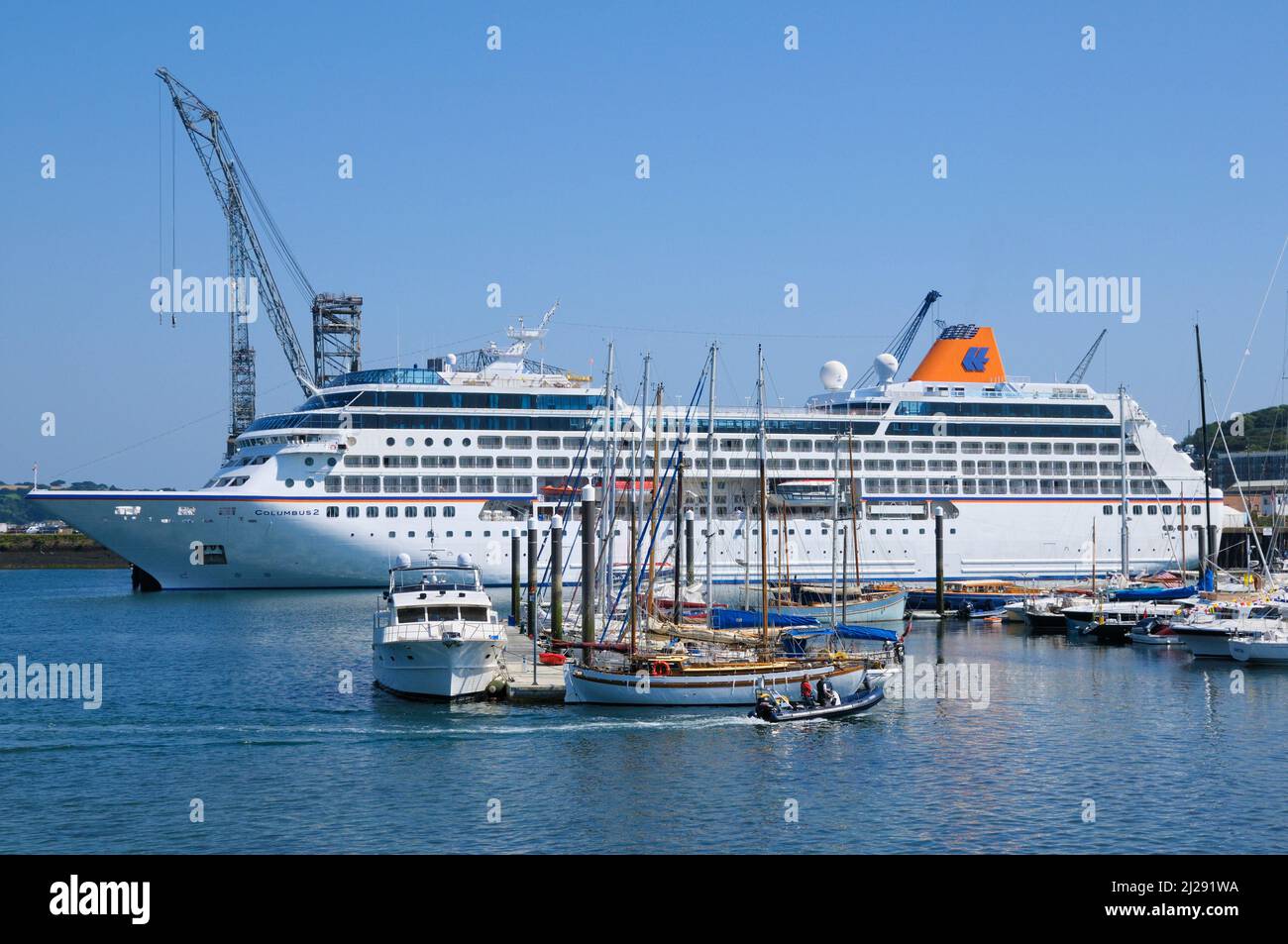 Luxury cruise ship docked in Falmouth Harbour dwarfing the sailing boats in Port Pendennis Marina, Falmouth, Cornwall, England, UK Stock Photo