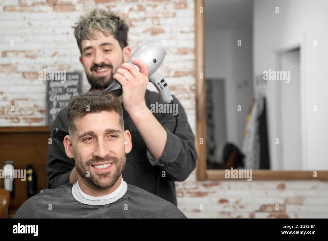 Barber drying client hair dryer hi-res stock photography and images - Alamy