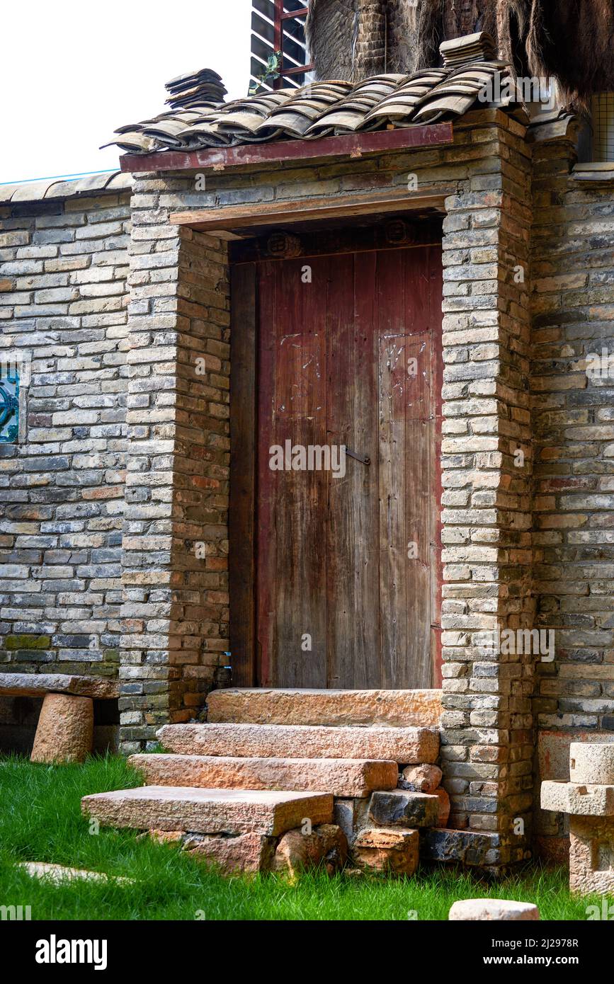 Close-up of wooden door of brick house in ancient Chinese architecture ...