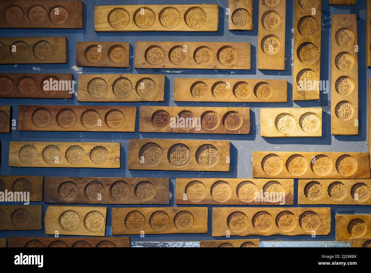 Wall full of Chinese moon cake moulds hanging on the wall Stock Photo