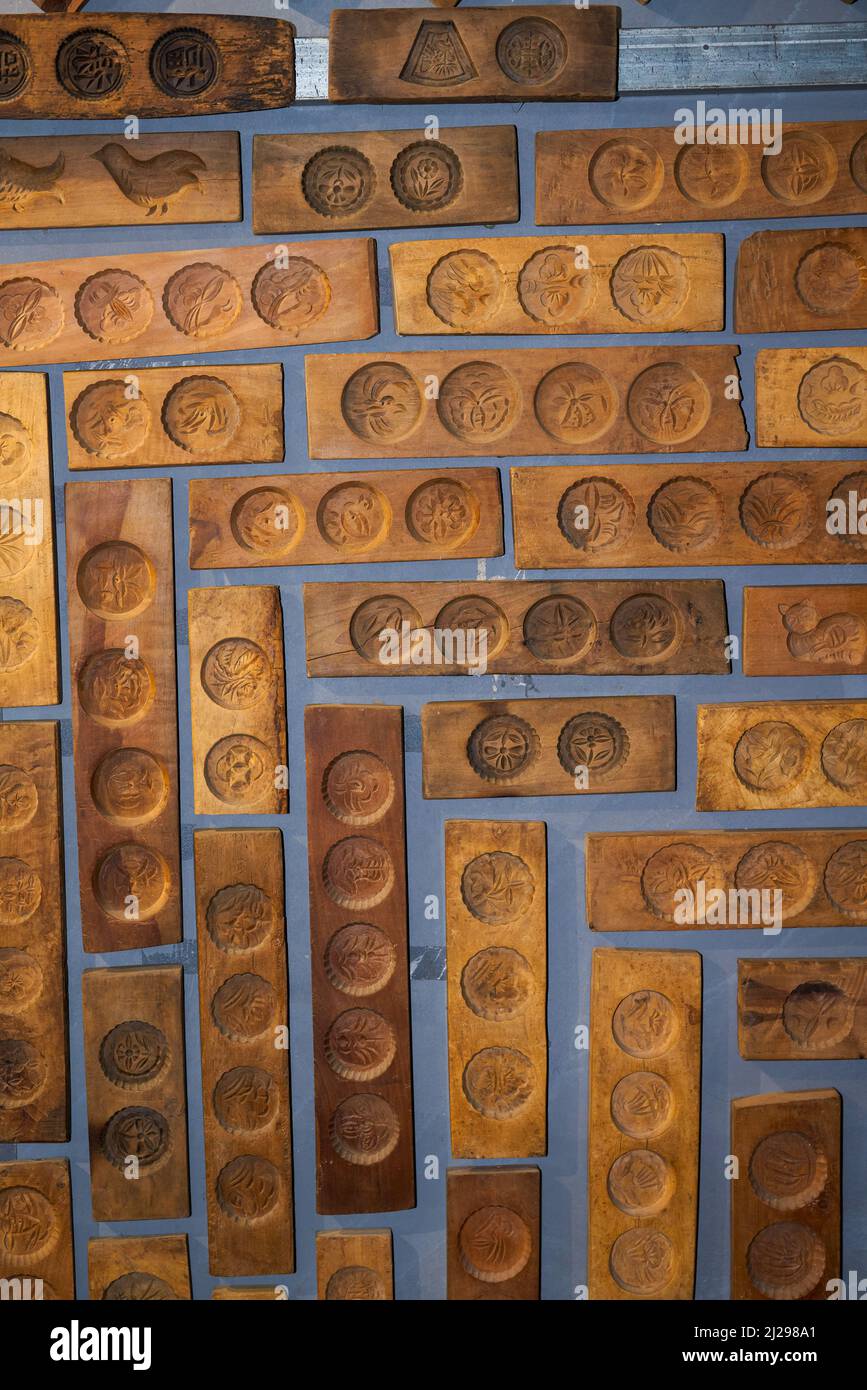 Wall full of Chinese moon cake moulds hanging on the wall Stock Photo