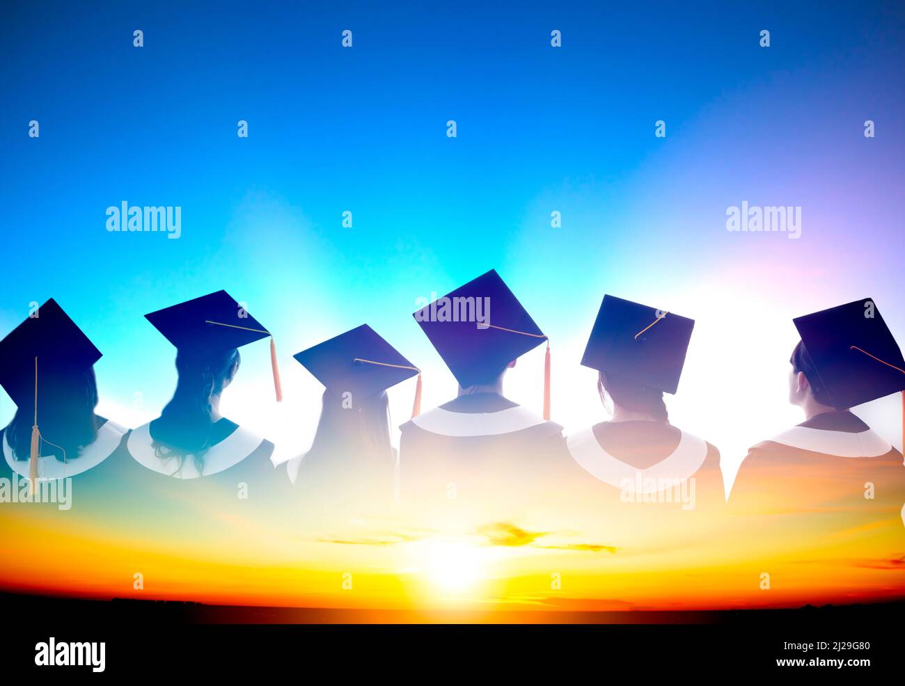 Double exposure of Silhouette graduation group celebrating and watching the sunrise Stock Photo