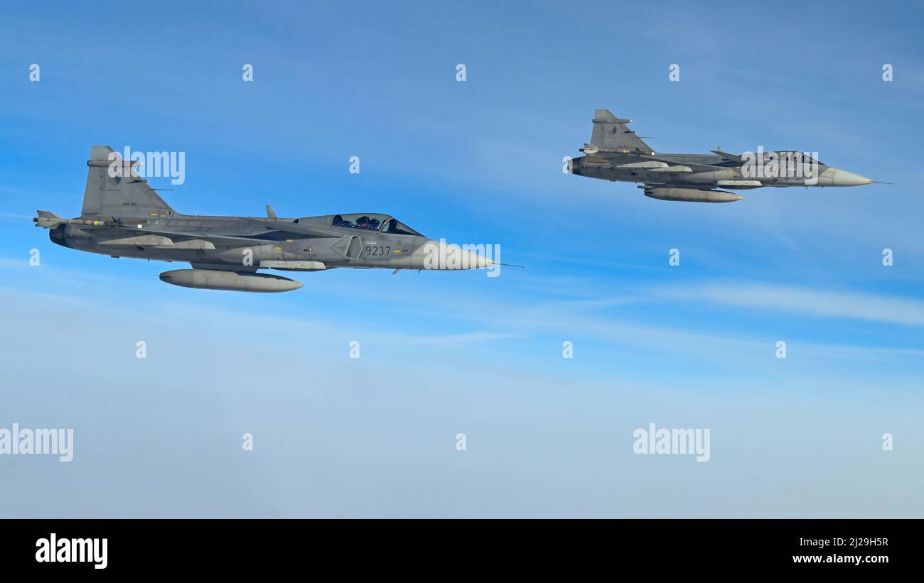 Two Czech Air Force Saab JAS-39 Gripen fly in formation alongside a B-52H Stratofortress assigned to the 69th Expeditionary Bomb Squadron at RAF Fairford, England, as a part of the pre-planned Bomber Task Force Europe series of missions, March 29, 2022. B-52s from the 69th EBS flew to the Czech Republic to integrate with U.S. Allies in an effort to strengthen fighter-bomber interoperability. (U.S. Air Force photo by Airman 1st Class Zachary Wright) Stock Photo