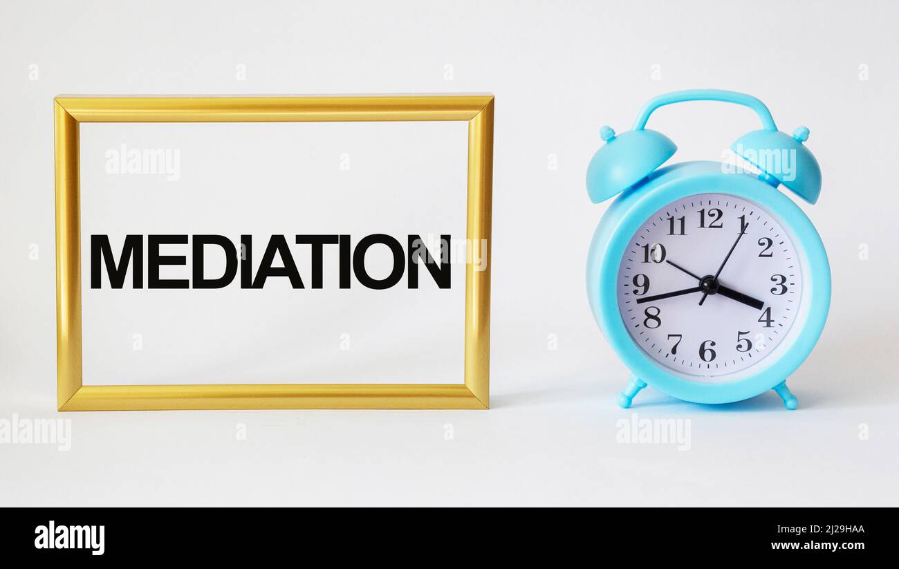 intermediary word - isolated text in golden frame and white background with clock Stock Photo