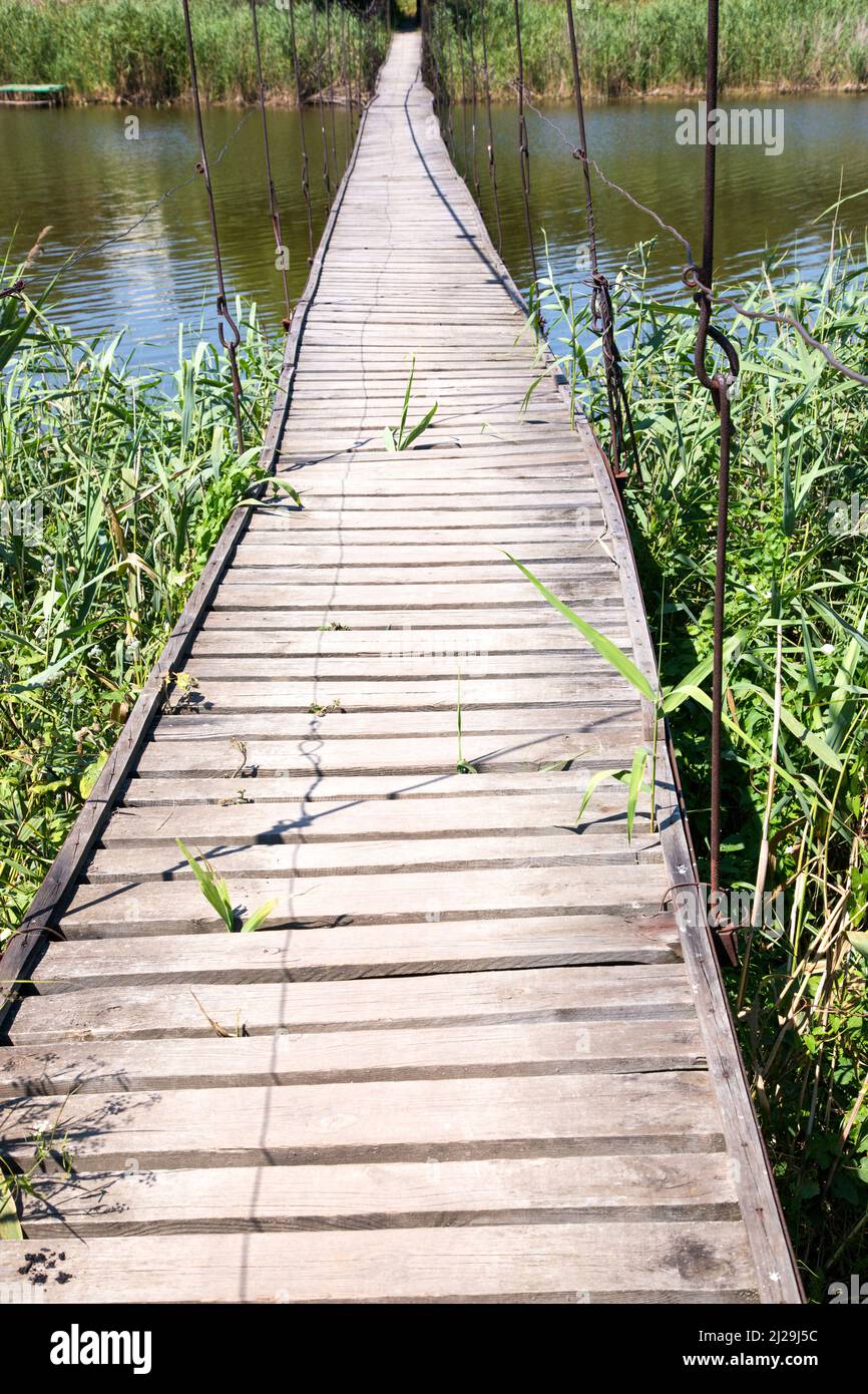 Makeshift wooden bridge over water Stock Photo - Alamy