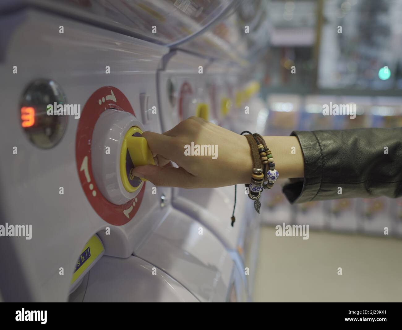 Hand using toy vending machine Stock Photo Alamy