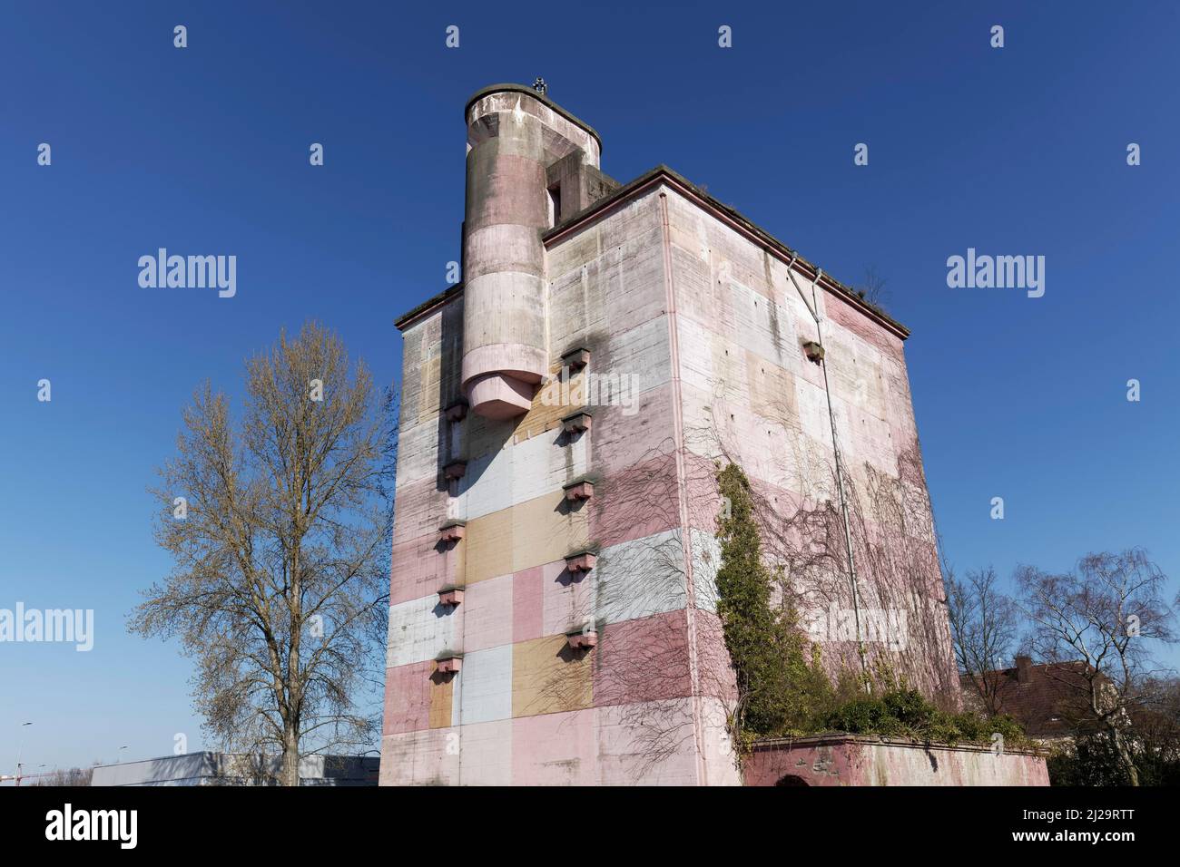 High bunker from World War 2 on the Bayer AG factory premises, facade painted pink, Leverkusen, North Rhine-Westphalia, Germany Stock Photo