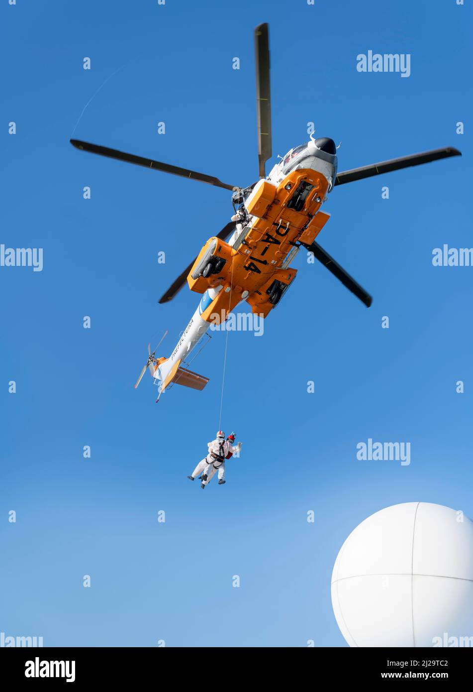 Two doctors are roped down from a helicopter onto a cruise ship. Corona tests are to be carried out in the Atlantic Ocean at the height of Argentina. Stock Photo