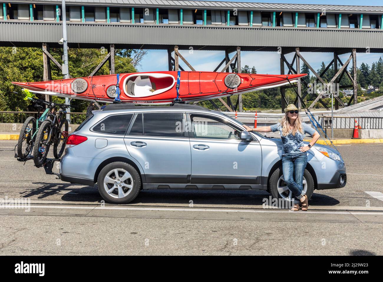Waiting for the ferry with the car, mountain bikes and sea kayaks. Stock Photo