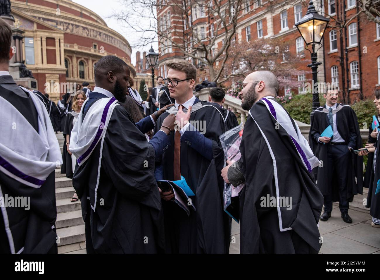 Imperial College London graduates enjoy the atmosphere outside the Royal Albert Hall although parents or family members were not allowed to attend. Stock Photo