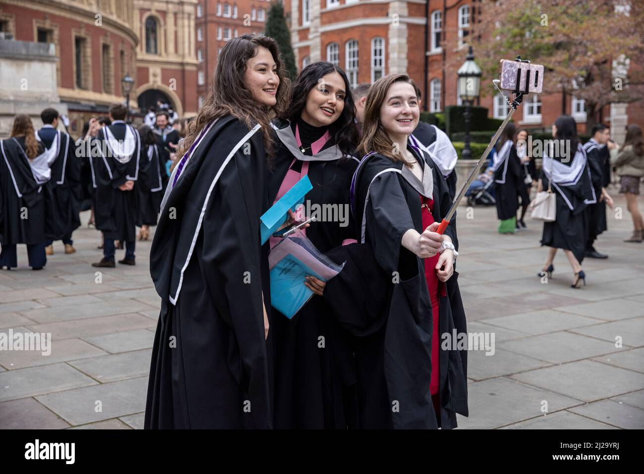 Imperial College London graduates enjoy the atmosphere outside the ...