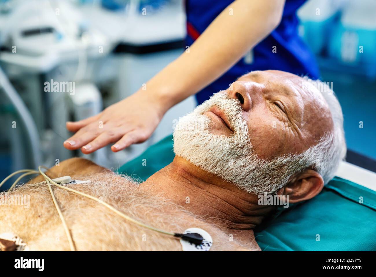 ECG electrodes on mature male patient in hospital before surgery. Healthcare and medicine