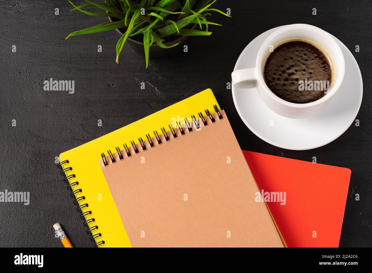 Three notepads on a black table close up Stock Photo