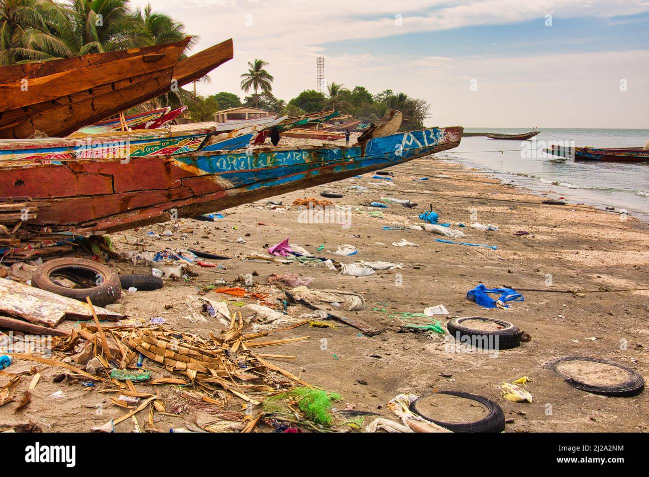 WARANG, MBOUR, SENEGAL - Circa JANUARY 20222. Beach sand of atlantic ocean with so many garbage plastic pollution in Senegal Africa. No place for tour Stock Photo