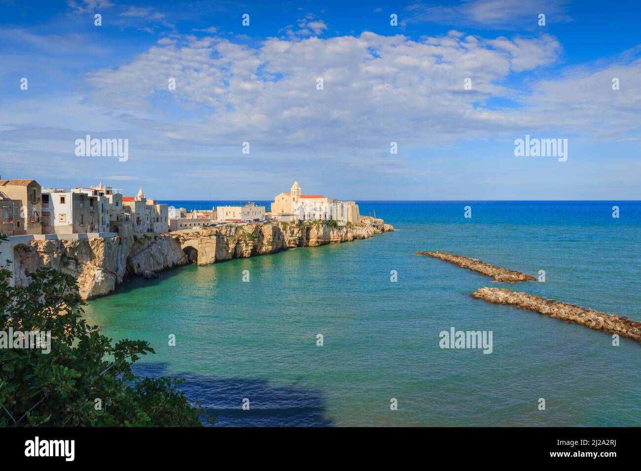 Gargano coast: bay of Vieste, (Apulia) Italy. Panoramic view of the old town. The medieval center perches on a small rocky peninsula. Stock Photo