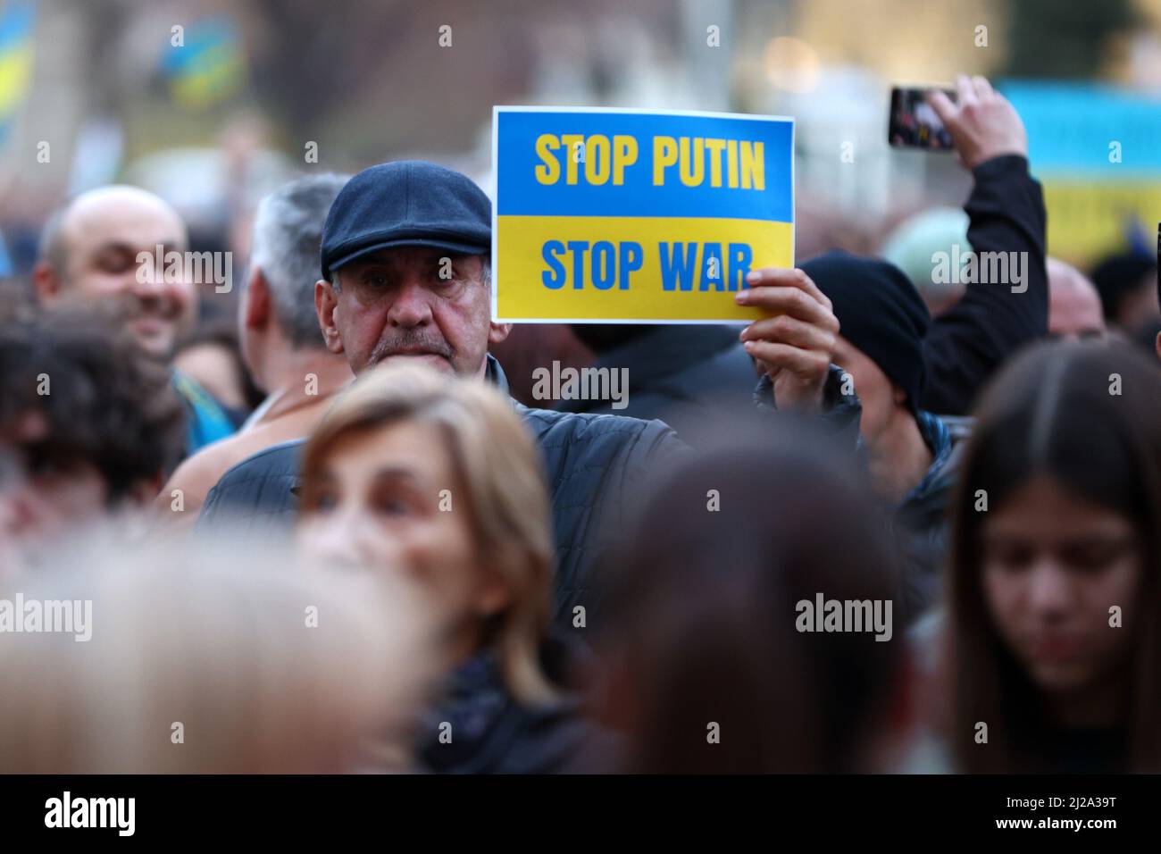 Sofia, Bulgaria - 24 March 2022: A man holds protest sign saying 'Stop Putin Stop War' during a demonstration in support of Ukraine one month after Ru Stock Photo