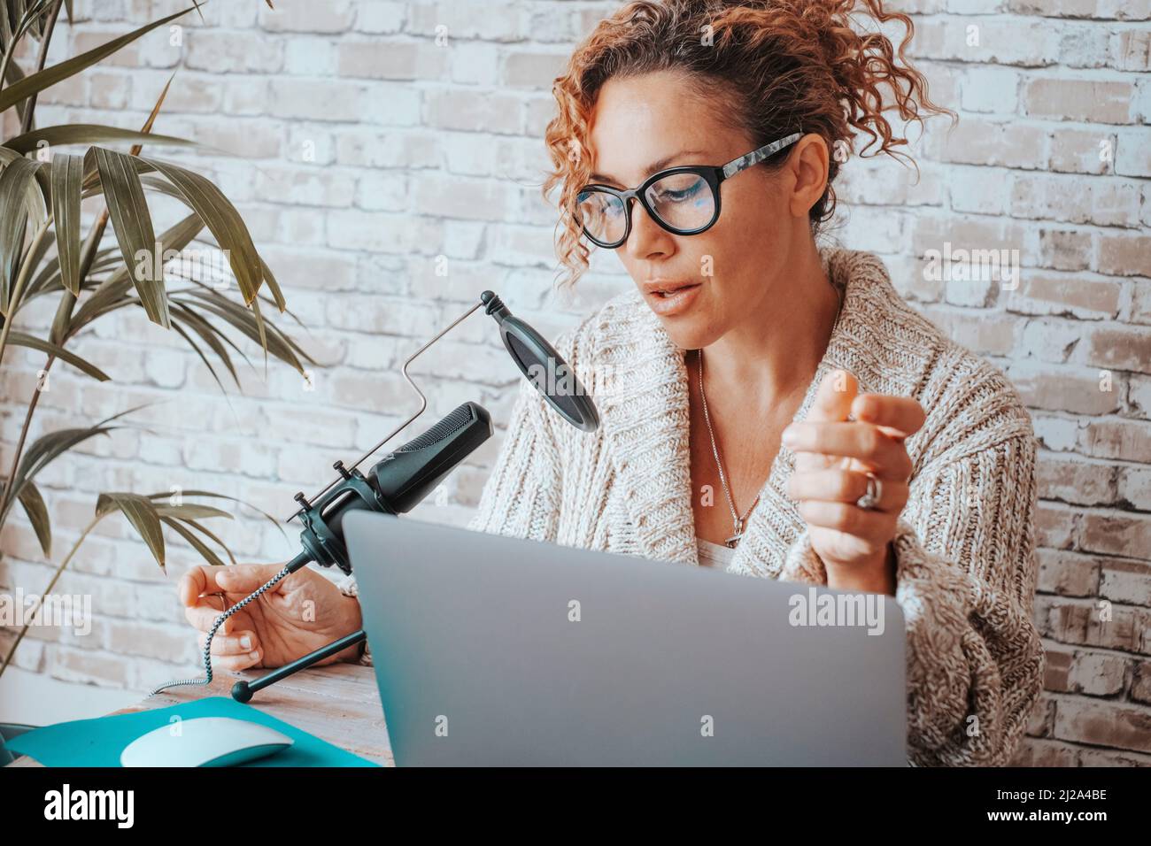 Online woman content creator do podcast speaking on microphone and ...