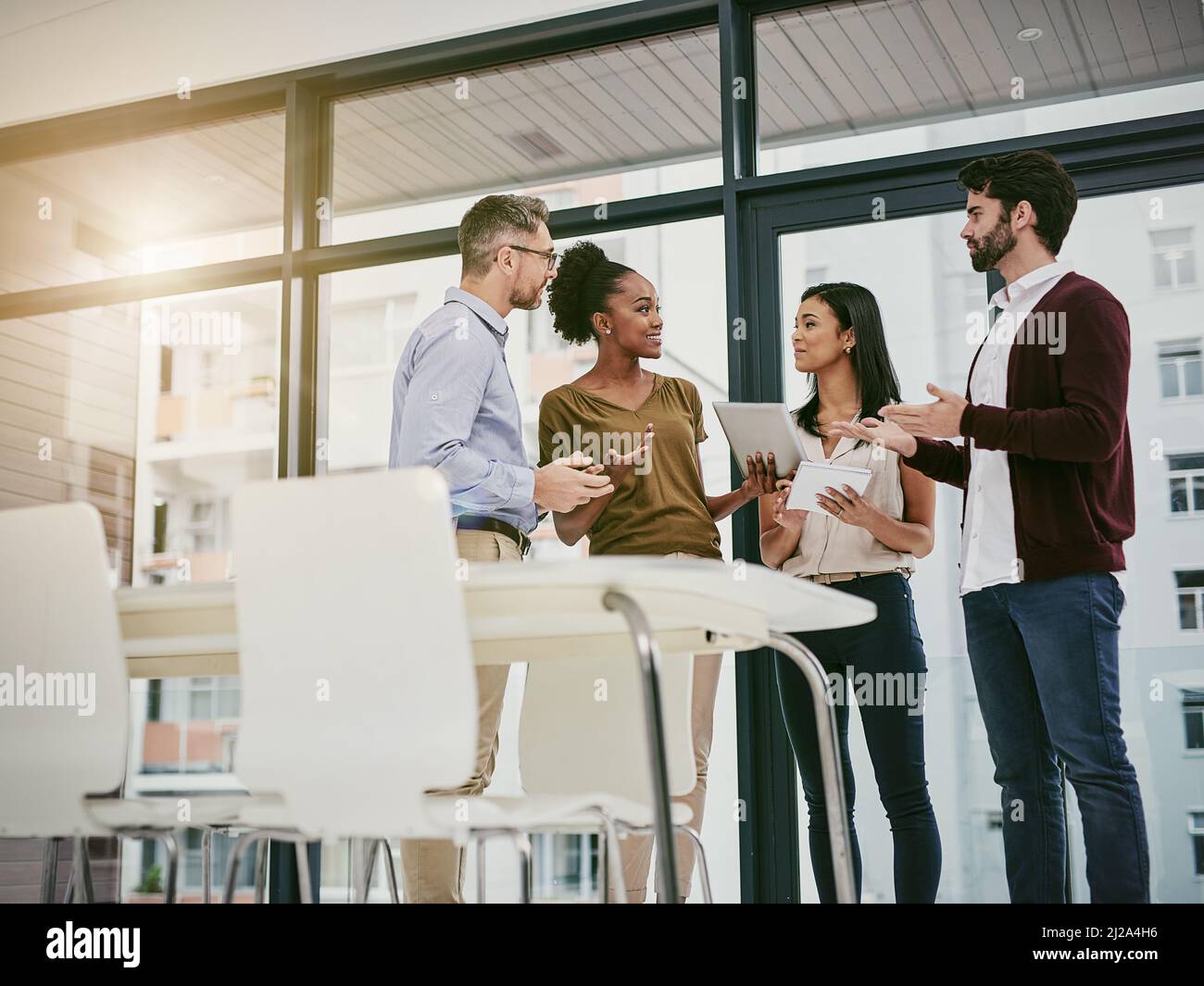 Discussing the status of business. Shot of a group of colleagues having a meeting in a modern