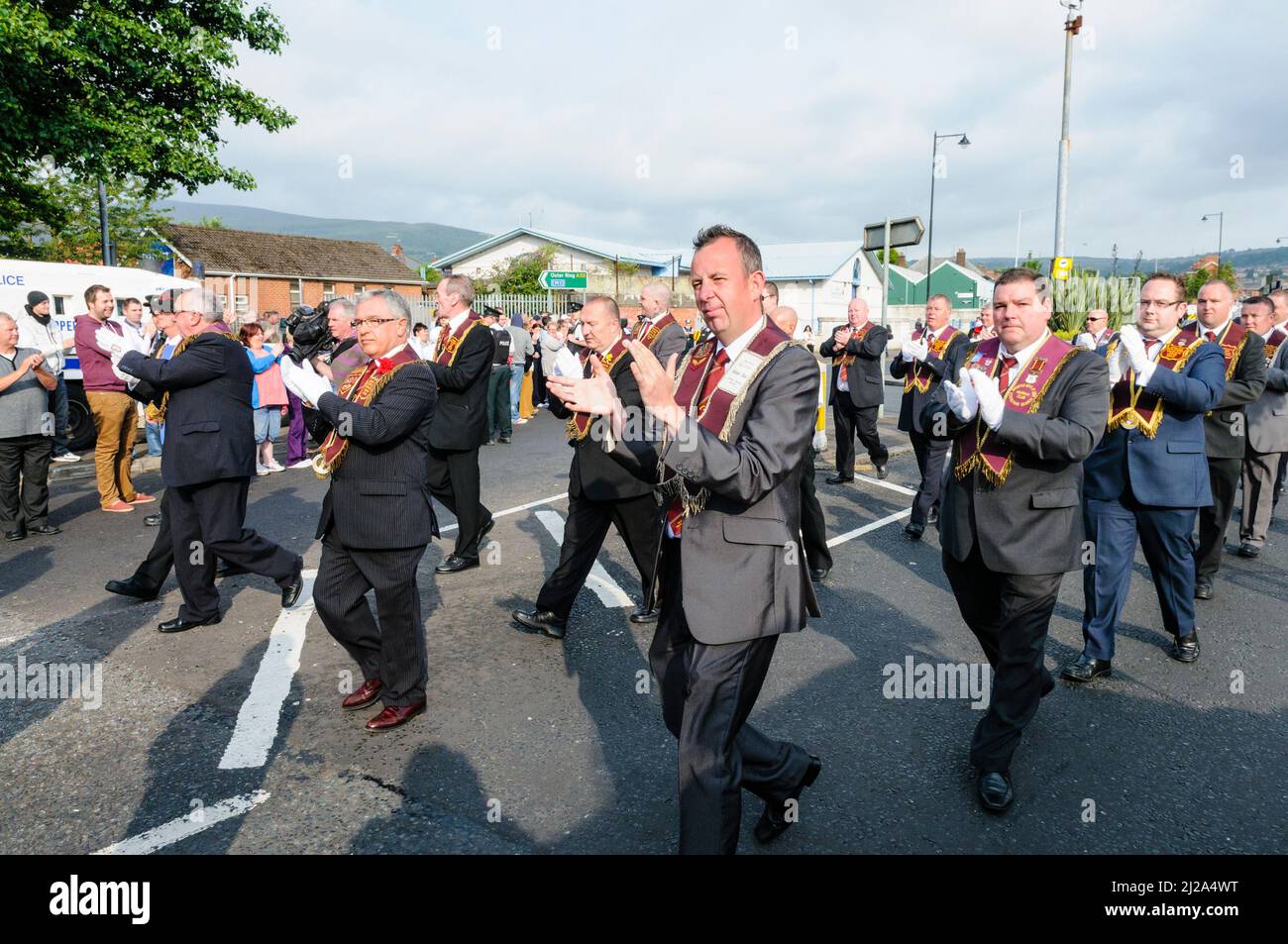 11th August 2012, Belfast.  Apprentice Boys of Derry lodge members applaud their supporters as they parade past Ardoyne protesters. Stock Photo