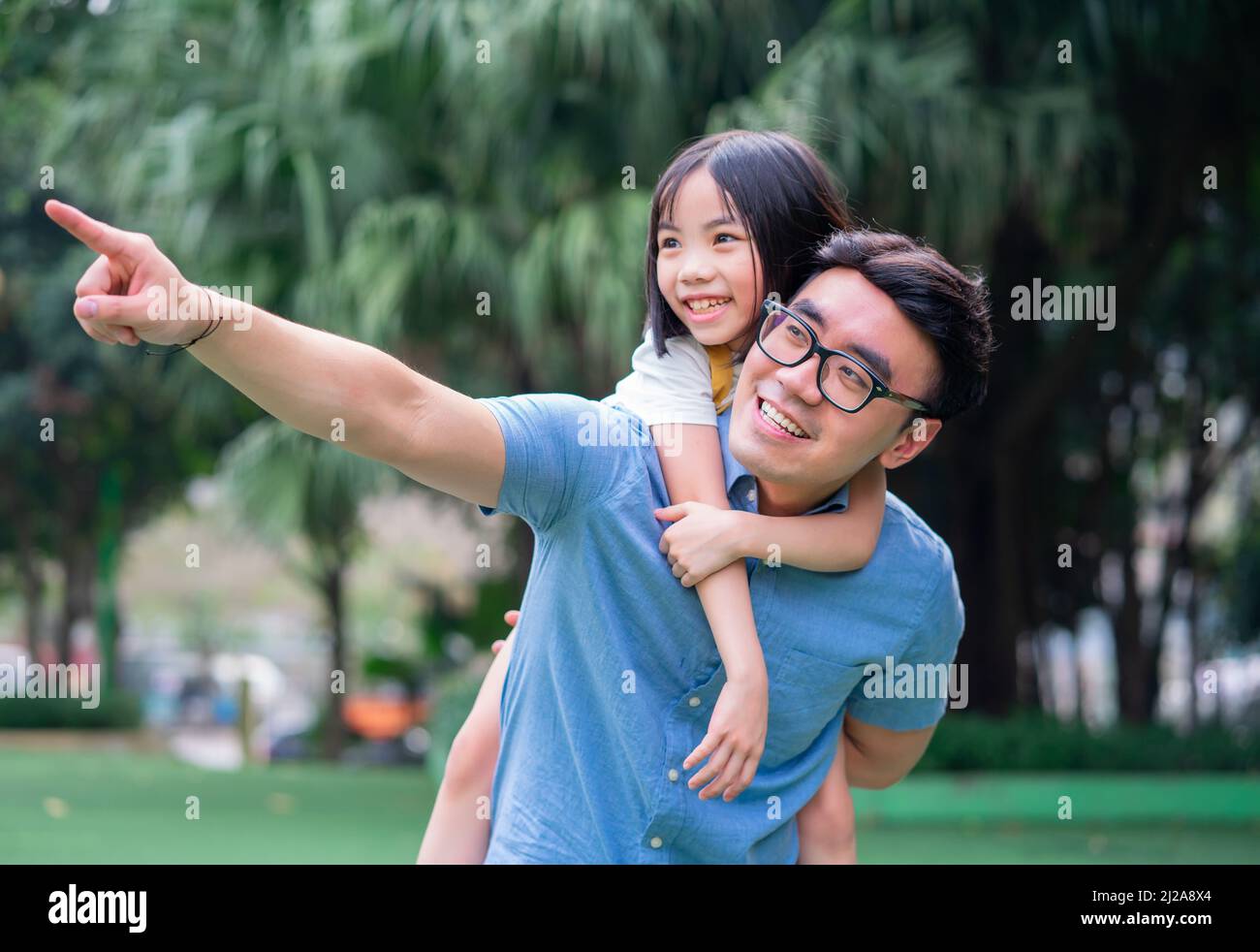 Image of Asian father and daughter playing together at park Stock Photo ...