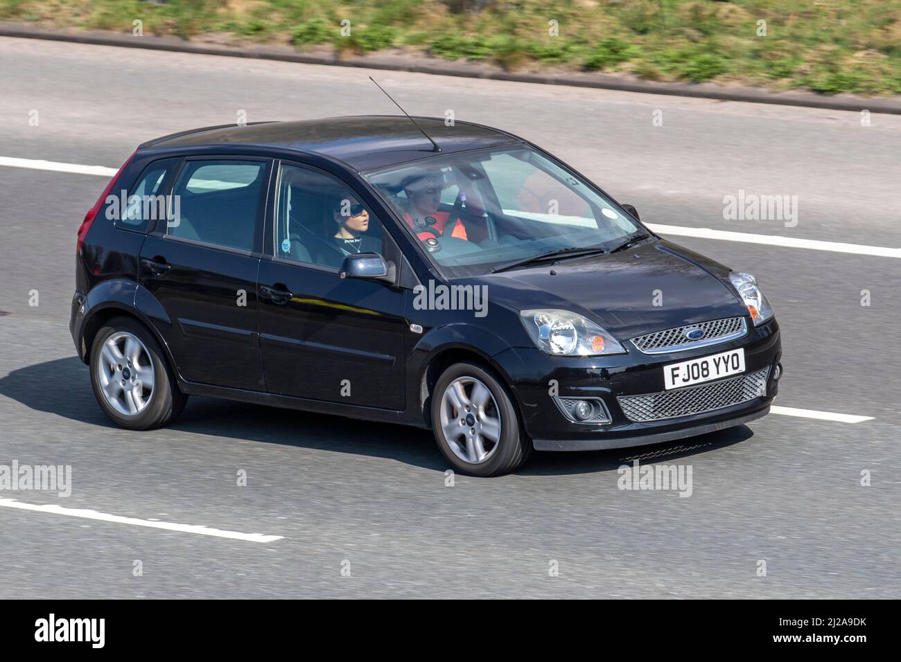 2008 black Ford Fiesta Zetec Climate 16V 5 speed manual 4dr driving on the M61 motorway UK Stock Photo