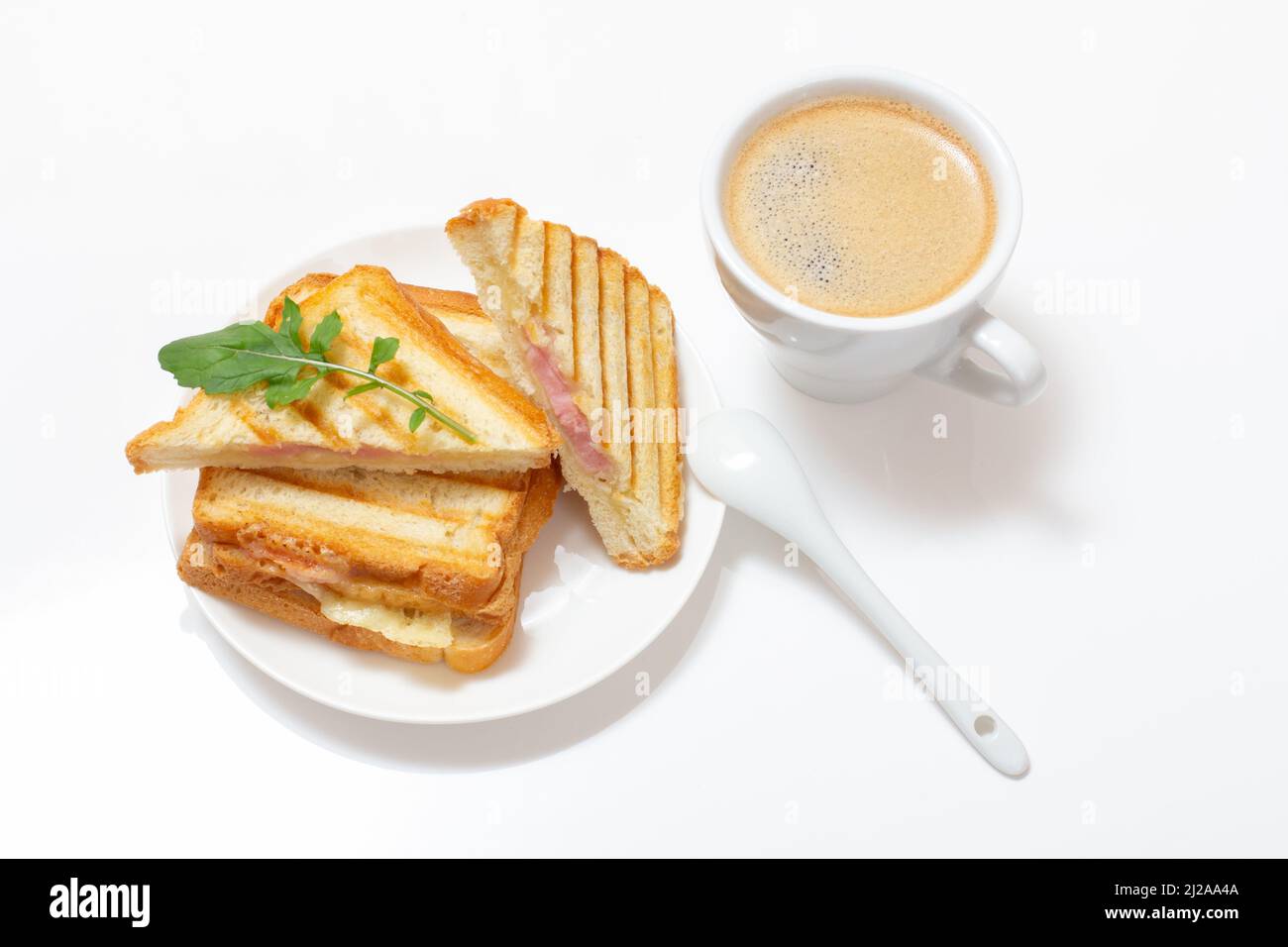 Homemade grilled cheese sandwich for breakfast on a plate and a cup of