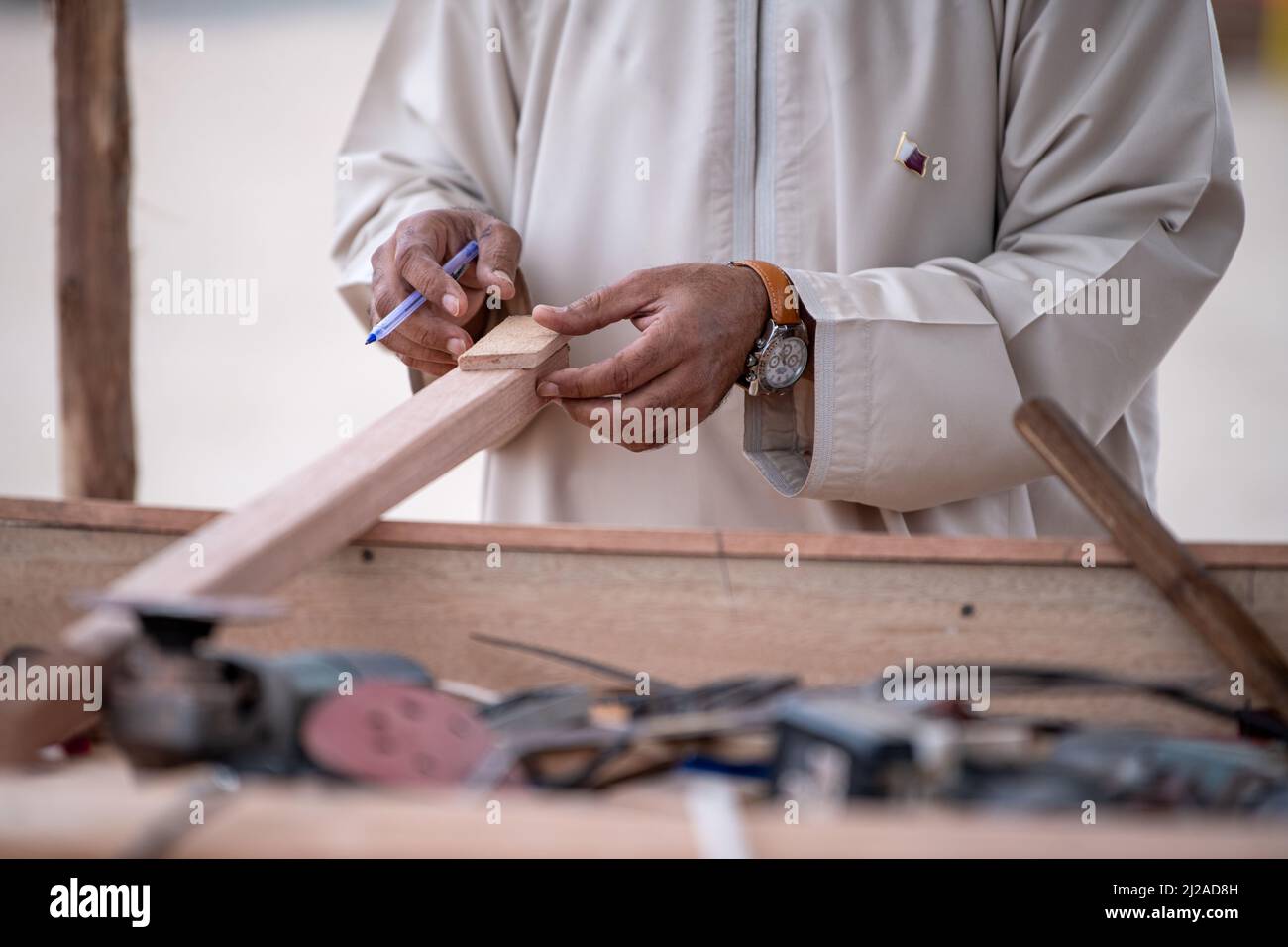 Worker Hands Details Of Wood Cutter Machine With A Circular Saw And Wooden Board Stock Photo
