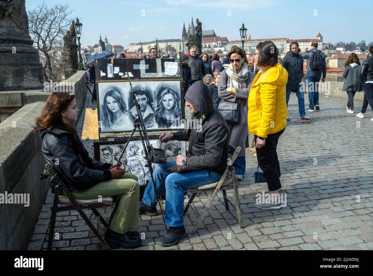 A street artist drawing a picture of a tourist at The Charles Bridge, Prague, Czech Republic. Stock Photo