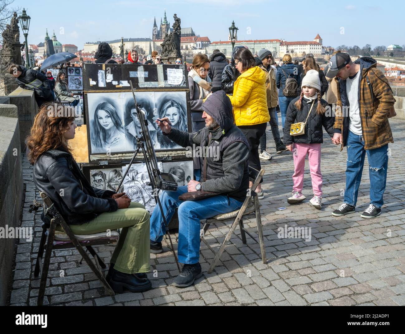 A street artist drawing a picture of a tourist at The Charles Bridge, Prague, Czech Republic. Stock Photo