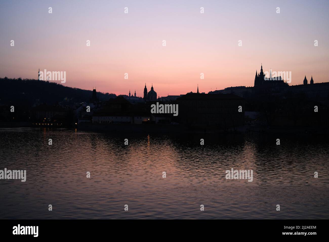 Dusk settles across the Vltava River in central Prague, Czech Republic. Stock Photo
