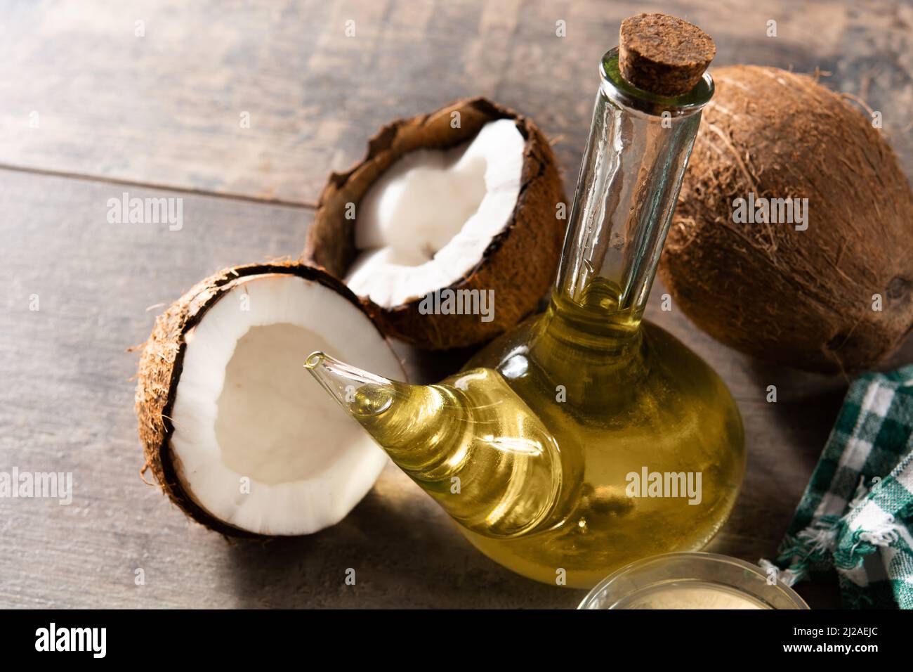 Coconut oil on wooden table Stock Photo Alamy