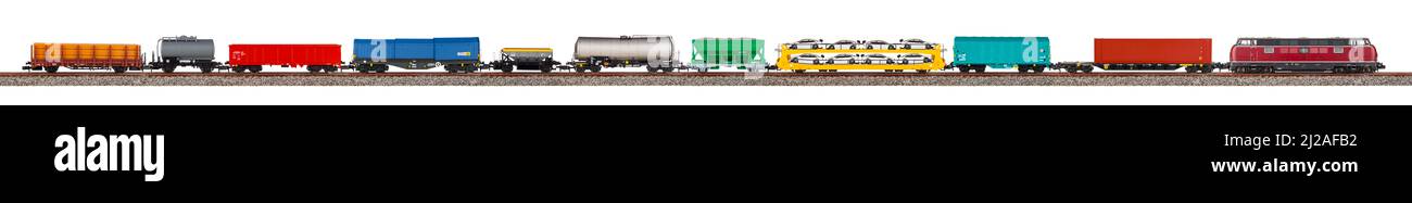 model railway freight train with colorful wagon isolated on white wide panorama background.  railroad hobby transportation logistic concept Stock Photo