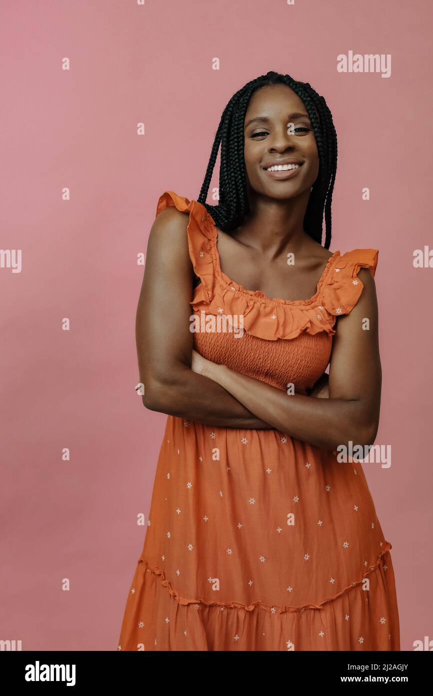 smiling african lady posing with crossed arms and looking at camera portrait Stock Photo