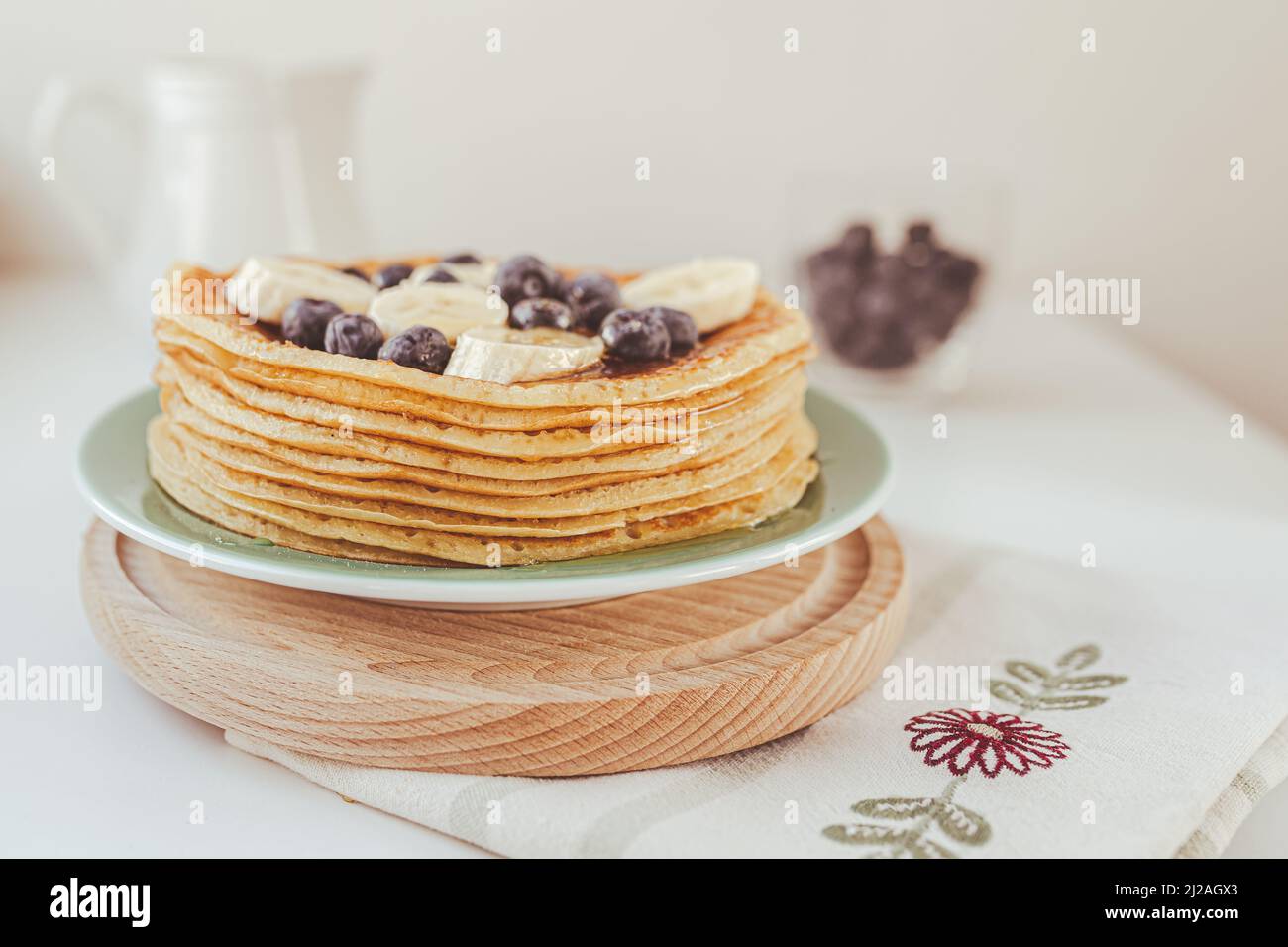 Delicious sweet food dessert pancakes or cornmeal pancakes, diet product, sweet food, holiday baking. Pancakes with fresh blueberries, banana and hone Stock Photo