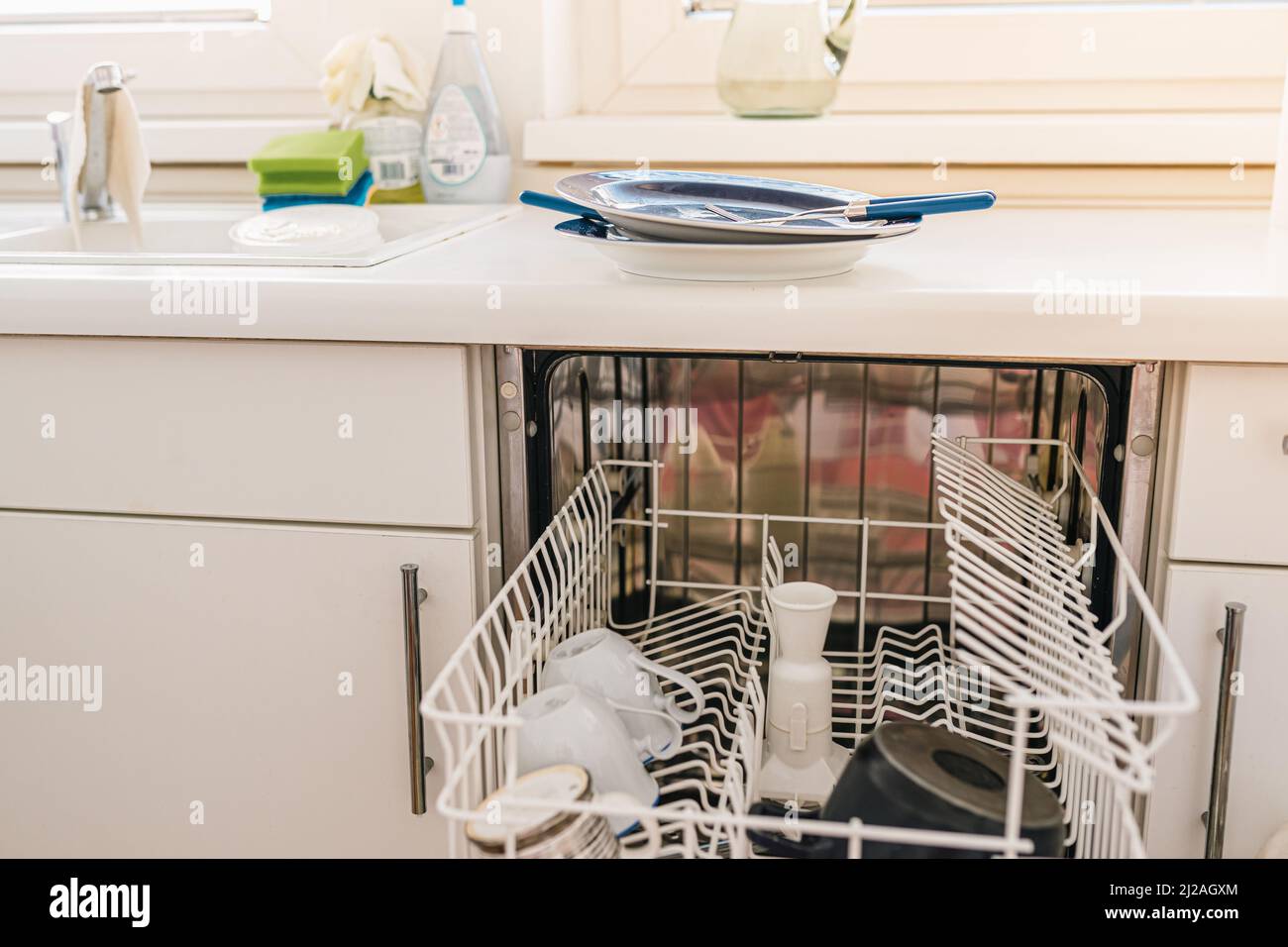 Kitchen with dishwasher, dirty dishes after breakfast. Dishwasher