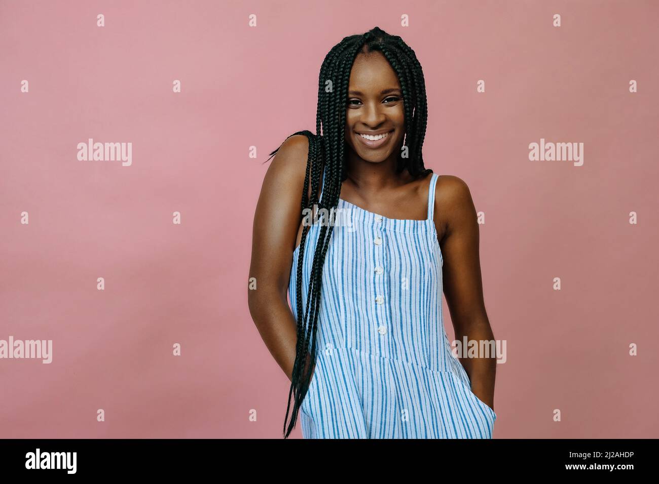 smiling young black woman with braids in studio portrait Stock Photo ...