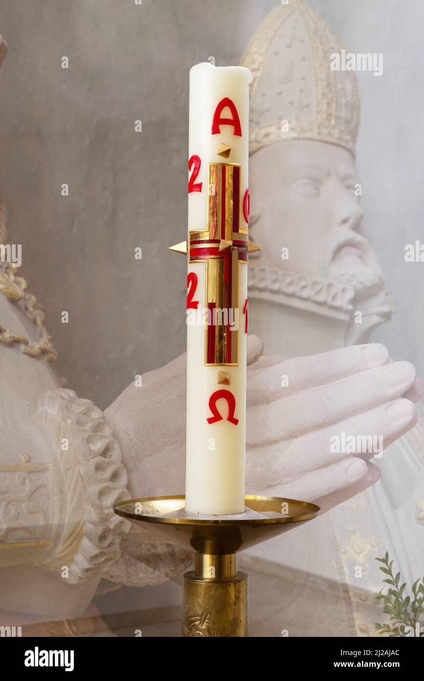 Paschal candle with religious background. A new Paschal candle is blessed and lit every year at Easter. Stock Photo