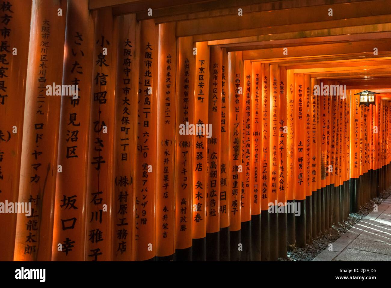 Horizontal lateral view of the Senbon Torii path in the Fushimi-Inari Taisha Shinto Shrine, Kyoto, Japan Stock Photo