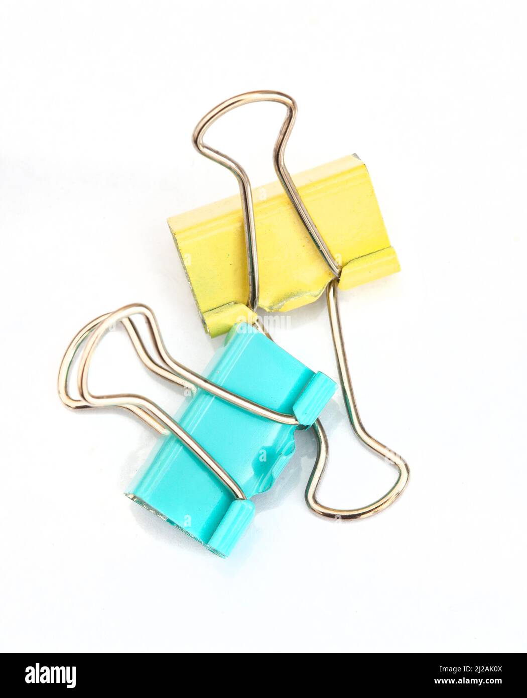 pastel colored paper clamping clip isolated on white background Stock Photo