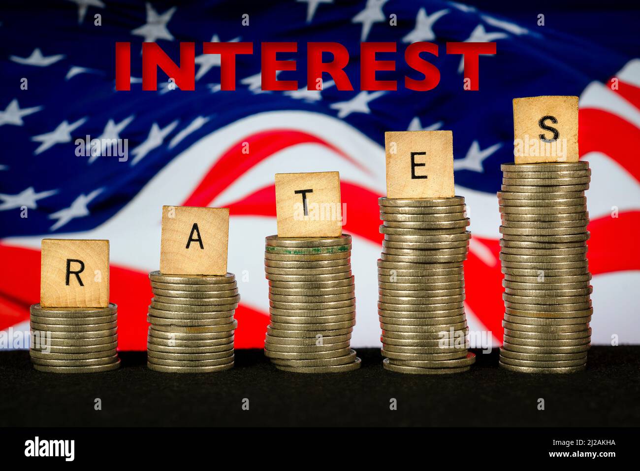 Interest Rates Rising text Coin Stacks American Flag Stock Photo
