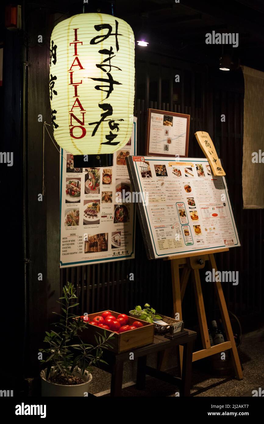 Vertical night view of an Italian restaurant exterior in Ponto-cho St, Kyoto Downtown, Japan Stock Photo