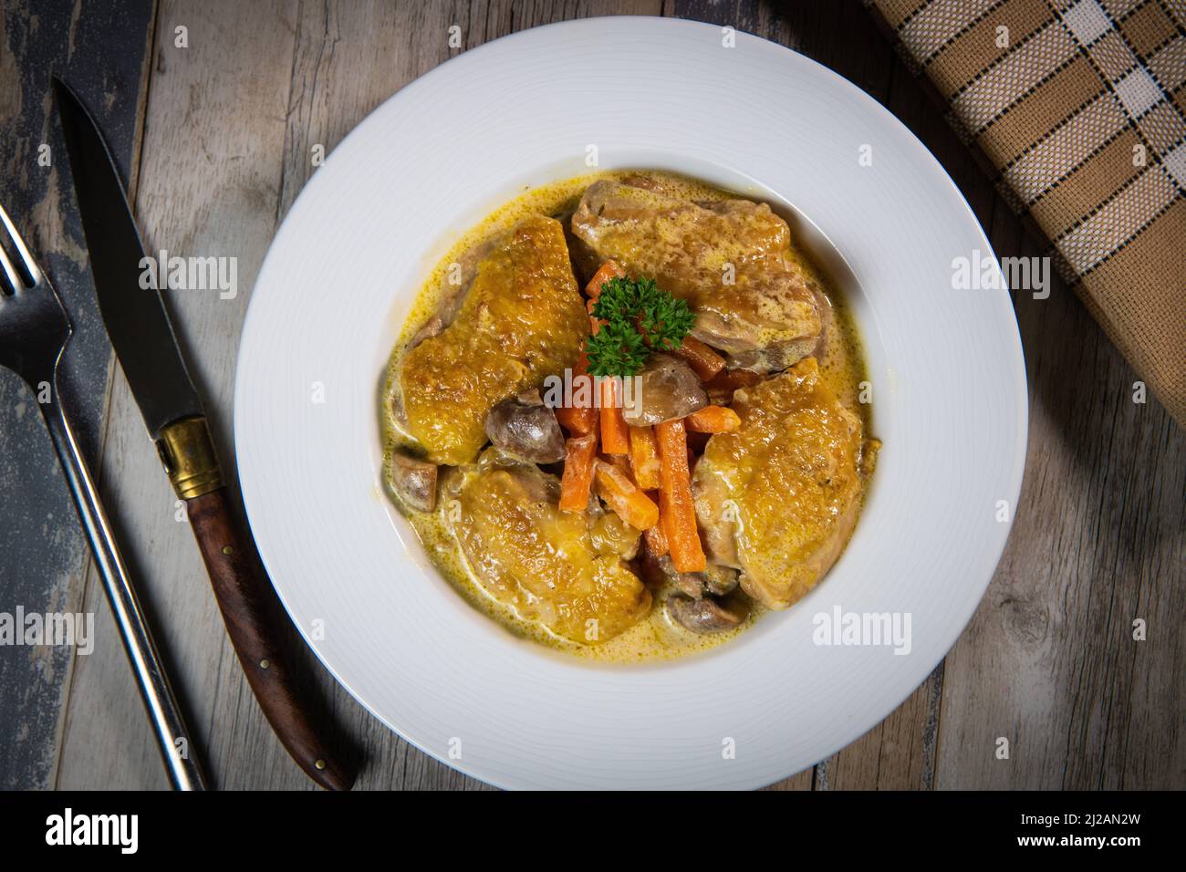 Recipe for chicken fricassee in white wine, with a carrot and mushroom planter Stock Photo Alamy
