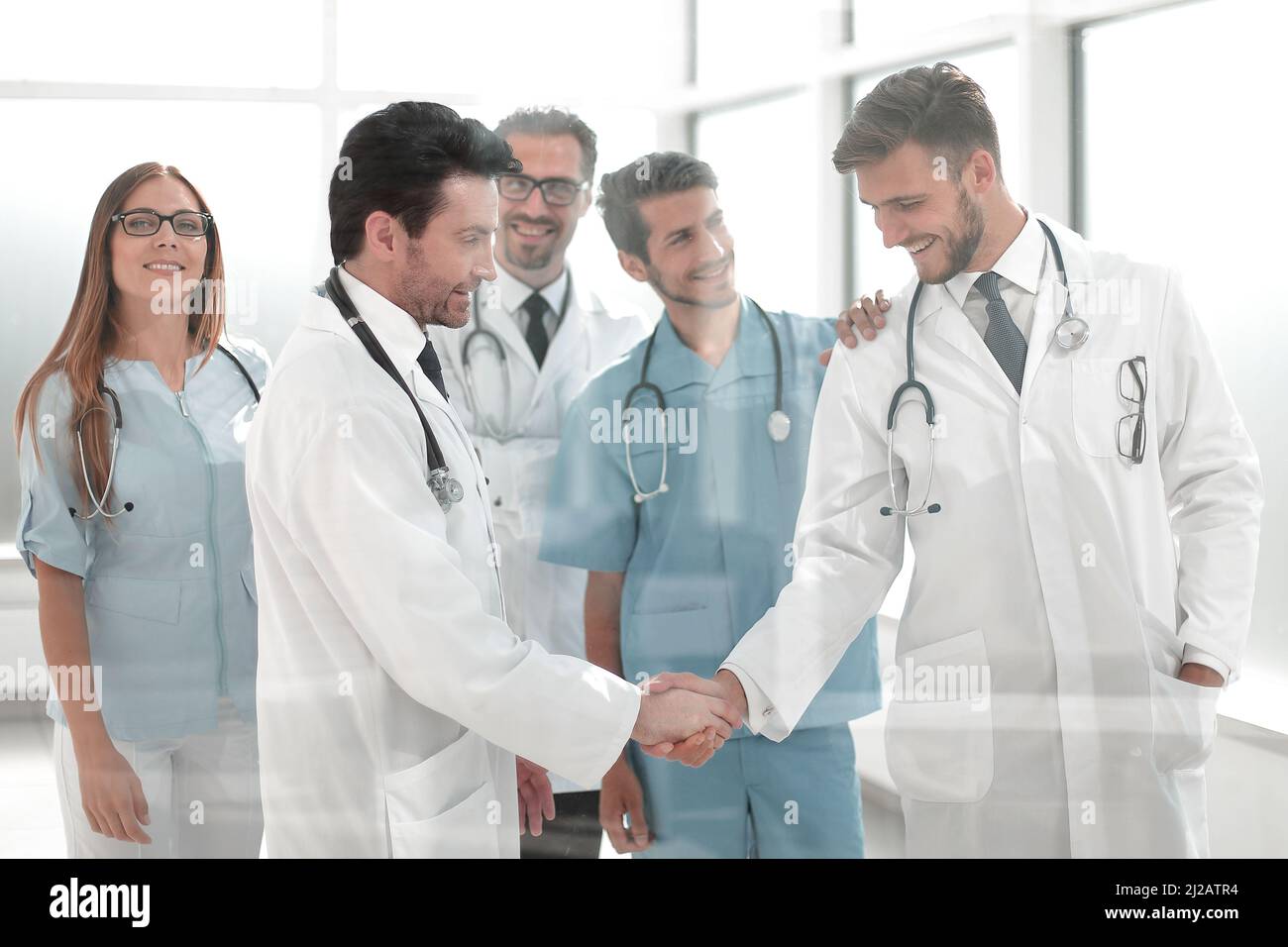 doctors shaking hands in hospital corridor Stock Photo Alamy