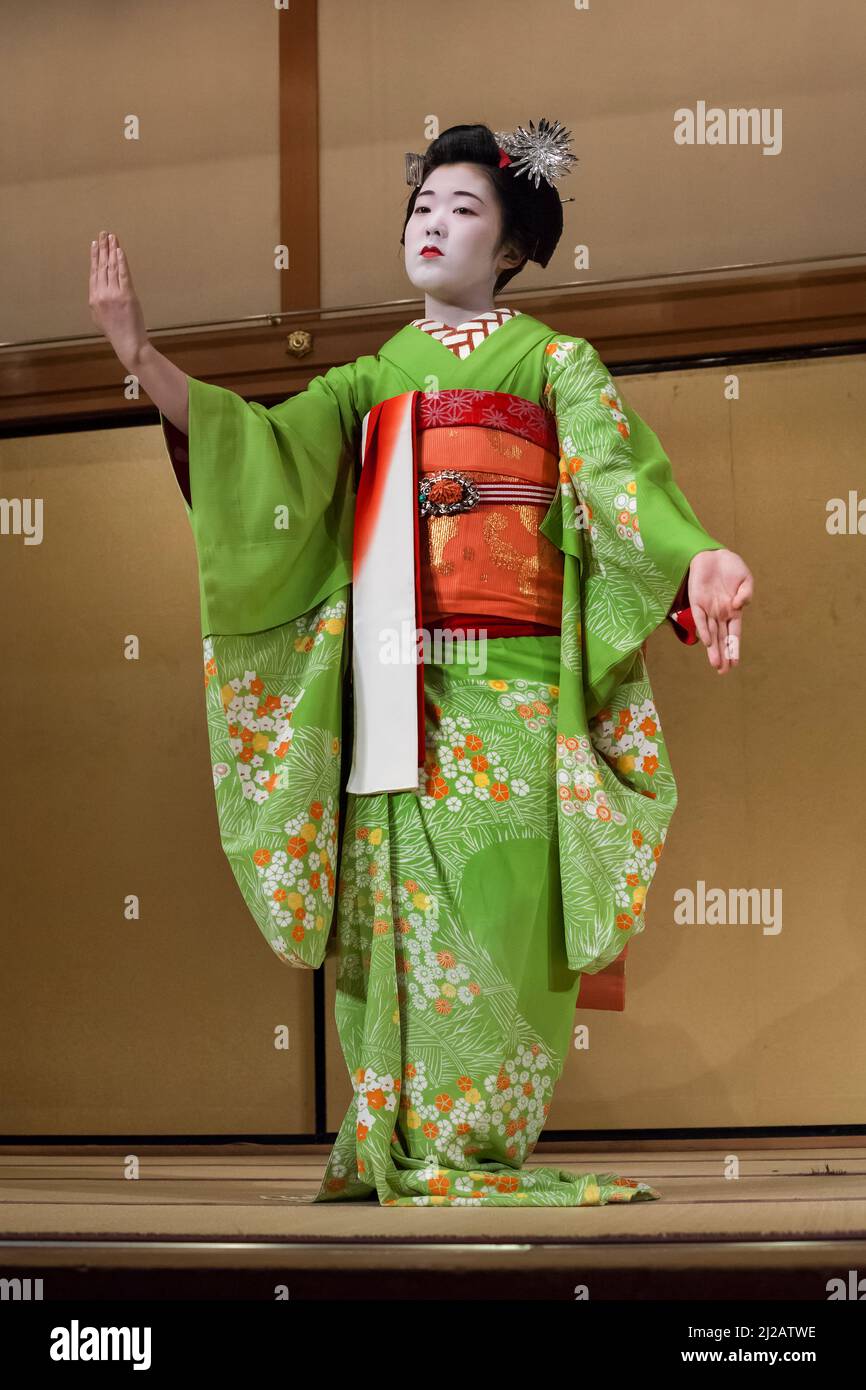 Vertical view of a geisha wearing a kimono in a Japanese traditional performance in Gion Corner, Gion Yasaka Hall Auditorium, Higashiyama, Kyoto Stock Photo
