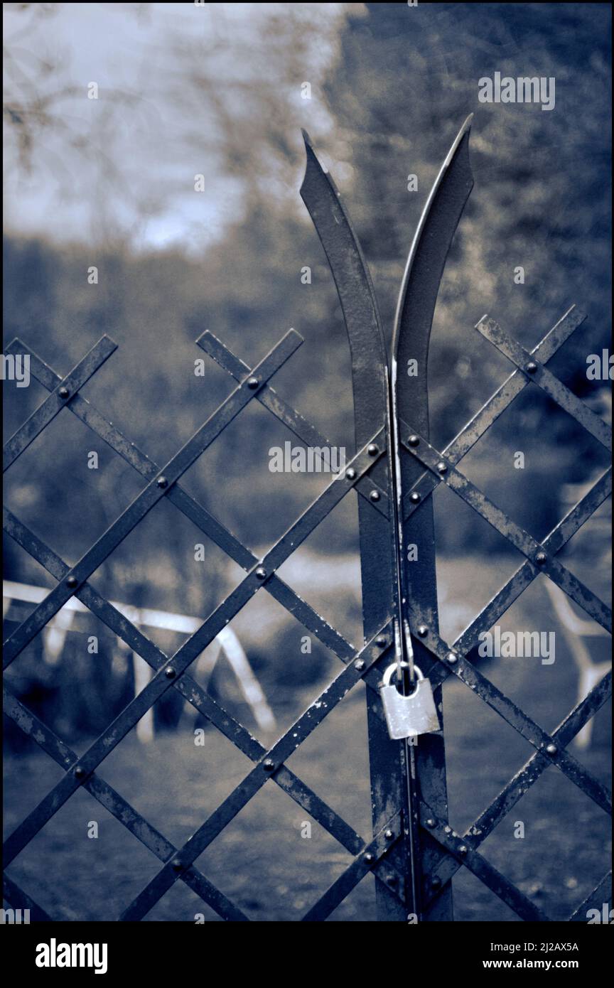 padlocked metal garden gate Stock Photo