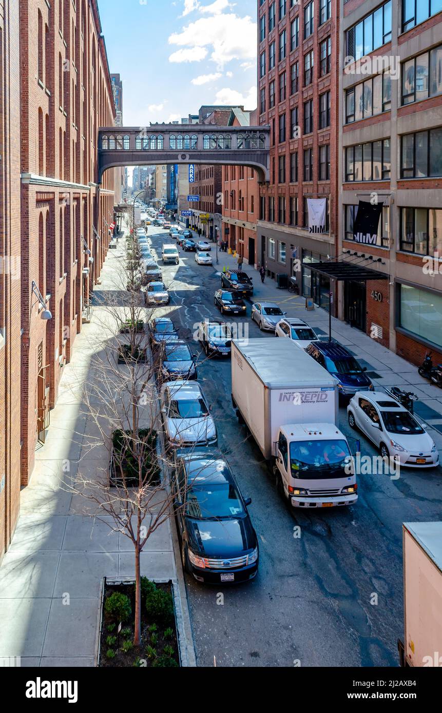 City street in Chelsea with cars and a truck passing by, aerial view ...