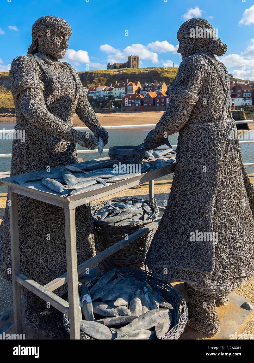 Wire statue of a fishwife at the harbor in the port of Whitby on the North Yorkshire coast in the northeast of England. Stock Photo